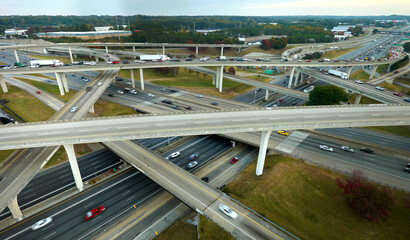 American freeway intersection with fast driving cars and trucks. View from above of USA...