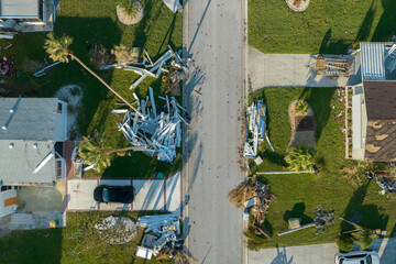 Heaps of debris rubbish on street side near severely damaged by hurricane Ian houses in Florida...