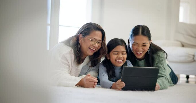 Laughing, tablet and happy kid, mom and grandma watch comedy film, social network meme and cartoon movie. Funny, and family child, mother and grandmother relax on floor, home lounge and reading comic