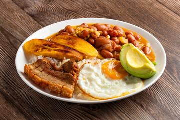 Bandeja paisa, typical dish at the Antioqueña region of Colombia. It consists of chicharrón (fried pork belly), black pudding, sausage, arepa, beans, fried plantain, avocado egg, and rice