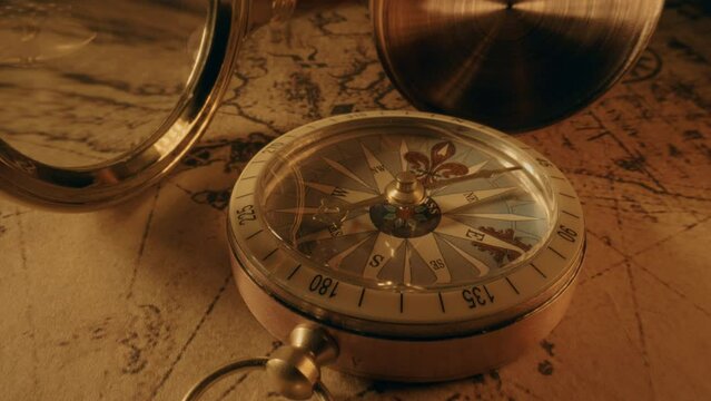 Compass and magnifier on a old vintage world map with countries and continents. Retro style. Concept of geography or global history and cartography. Wars of conquest and navigation. 4K ProRes