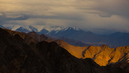 View of high-altitude mountains in Ladakh with sun rays and shadows falling on them. 