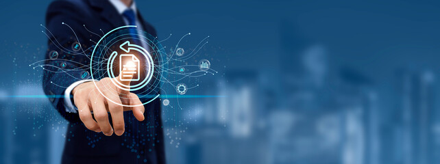 Backup button disaster recovery internet technology concept.
Businessman touching recovery on...
