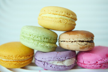 Close up of macaroon on blue background with copy space 