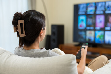 Woman watch TV at home © leungchopan