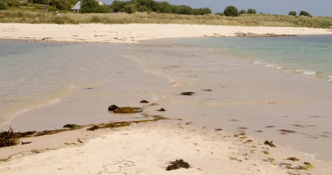 wide shot of the tide going over the sandbar on St Agnes and Gugh at the Isles of Scilly
