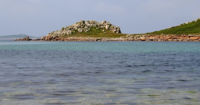 wide shot of the rock formation on the island of Gugh and taken from the sandbar on St Agnes at the Isles of Scilly