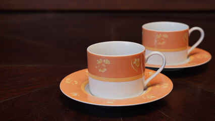 ceramic mug as seen from above on a dark wood dining room table.