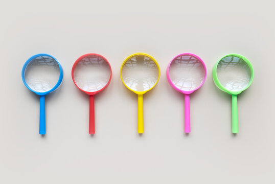 Colorful magnifying glass over a pastel background.