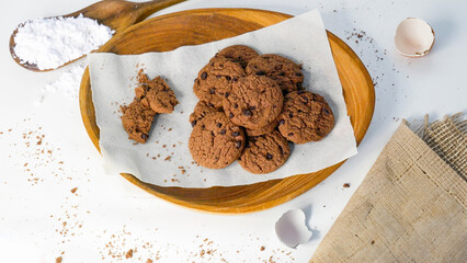 Pile of Delicious Chocolate Chip Cookies on a Wooden Plate. White background