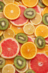 top down background view made of Fresh Sliced organic kiwi, oranges and lemons close-up