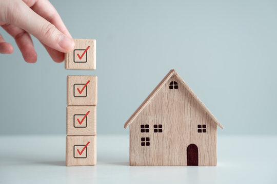 Home Buying Checklist And Hand Holding Complete Check Mark. Business And Financial, Hire A Real Estate, Refinance, House Purchase, Loan, Tax, Mortgage, Asset Management And Property Investment.