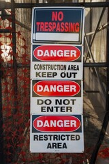 No Trespassing and danger signs at a construction site.