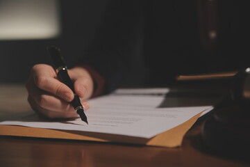 Business and lawyers discussing contract papers with brass scale on desk in office. Law, legal...