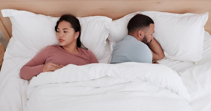 Couple in bedroom, fight and anger with conflict and communication fail, marriage and risk of divorce. Stress, angry people in bed at home and life crisis, betrayal and broken trust in relationship