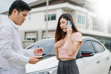 Woman and insurance agent claims process after car crash. with an Asian male Insurance Adjuster.