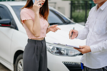 Woman and insurance agent claims process after car crash. with an Asian male Insurance Adjuster.