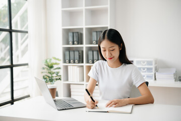 Business woman using tablet and laptop for doing math finance on an office desk, tax, report, accounting, statistics, and analytical research concept in office