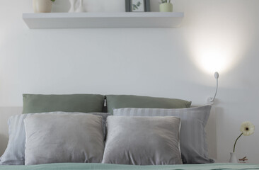 white bedroom with gray and green linens