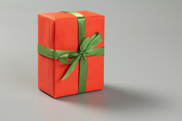 Gift box with a ribbon on the gray background.