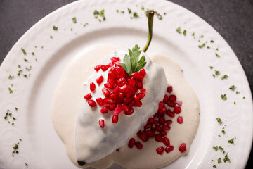 Chile en Nogada, Typical dish from Mexico. Prepared with poblano chili stuffed with meat and fruits and covered with a walnut sauce. Named as the quintessential Mexican dish for national holidays.