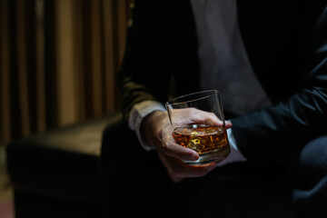 businessmen holding a glass of whiskey