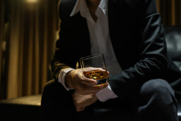 businessmen holding a glass of whiskey