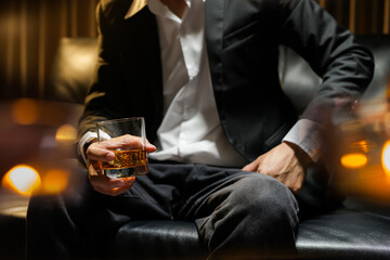 businessmen holding a glass of whiskey