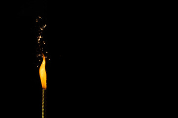 Close up of gas lighter with flames and copy space on black background
