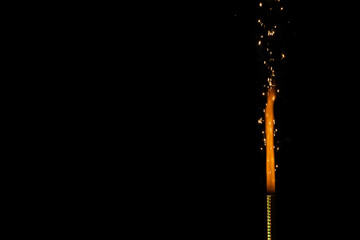 Close up of gas lighter with flames and copy space on black background