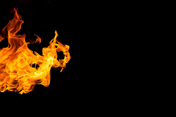 Close up of yellow and orange flames and copy space on black background