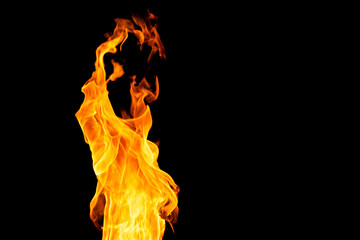 Close up of yellow and orange flames and copy space on black background