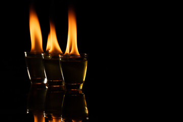 Three lit candles with copy space on black background
