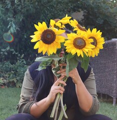 person with sunflowers