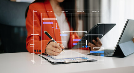 .Project manager working and update tasks with milestones progress planning and Gantt chart...