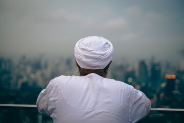 Man with white turban looking at the view