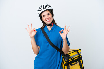 Young delivery woman with thermal backpack isolated on white background showing an ok sign with fingers