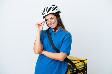 Young delivery woman with thermal backpack isolated on white background with glasses and happy