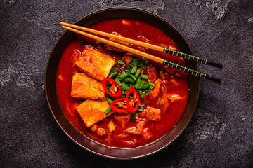 Korean traditional food, spicy kimchi soup (kimchi tige) with pork and tofu cheese.