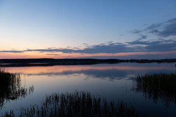 Fototapeta na wymiar multicolored sky during sunset on the lake
