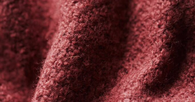 Micro video of close up of red wooly crochet fabric with copy space