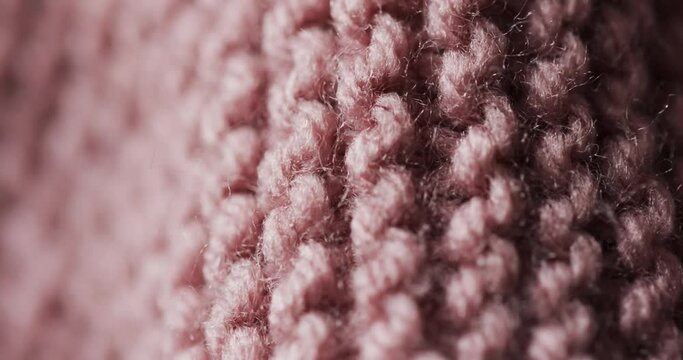 Micro video of close up of pink wooly crochet fabric with copy space