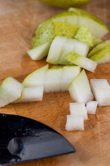 sliced green pear on a wooden board close-up