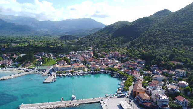 Aerial view of the port of the coastal village of Vasiliki in the south of the island of Lefkada, Greece. Beautiful crystal clear turquoise and blue waters