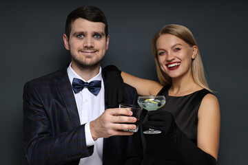 A woman and a man in Halloween costumes on a dark background