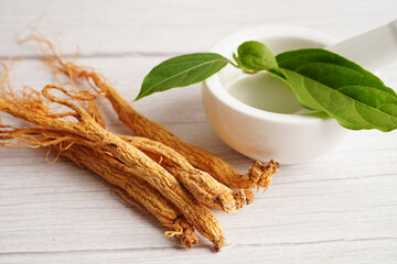 Ginseng roots and green leaf, healthy food.
