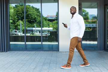 A young, successful African-American man with a smartphone in his hands