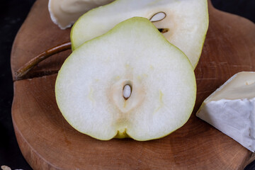 delicious and ripe pear on a wooden board