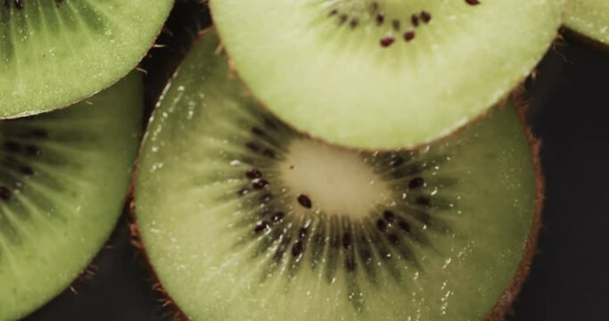 Micro video of close up of kiwi fruit slices with copy space
