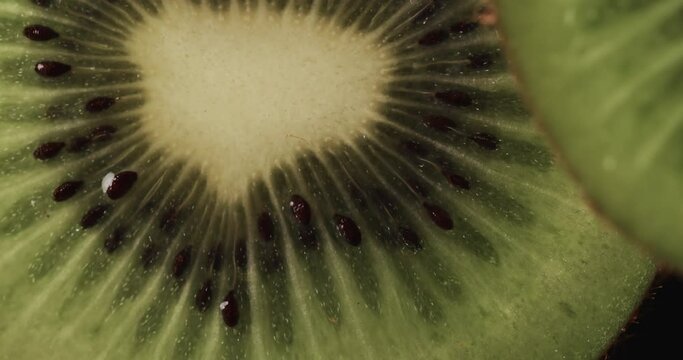 Micro video of close up of kiwi fruit slices with copy space